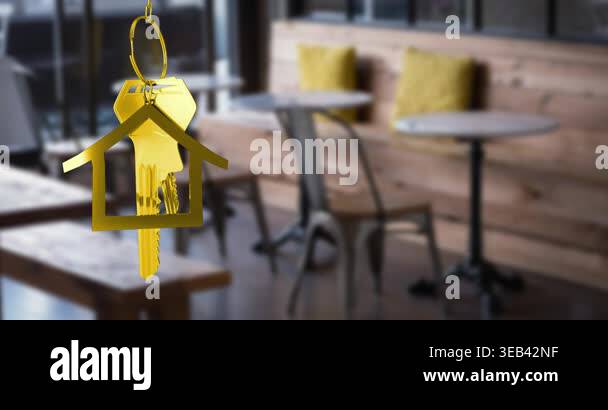 Animation of hanging golden house keys against interior of a cafe ...