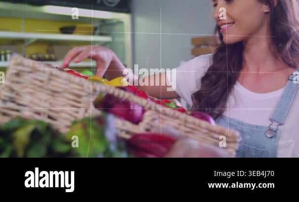 Woman reaching into bin, picking red pepper, checking before buying at ...