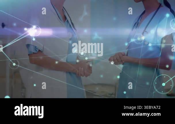 Two staff clasping hands, starting patient chat in ward, network ...