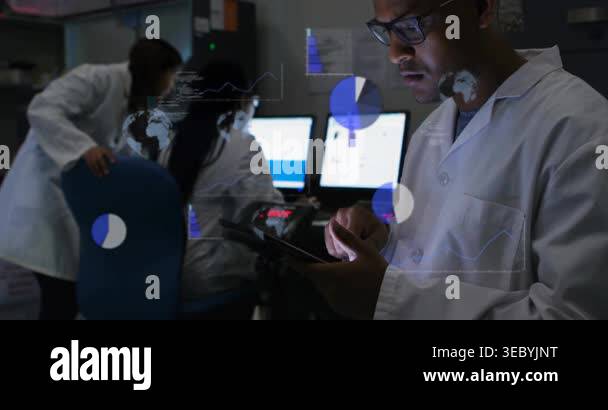 Man tapping tablet in lab monitoring room, causing animated charts and ...