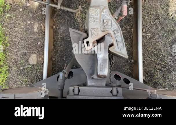 A close-up of an automatic railway coupling between freight cars. A ...