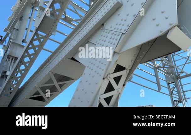 A low angle perspective shows the massive scale of gray steel girders ...