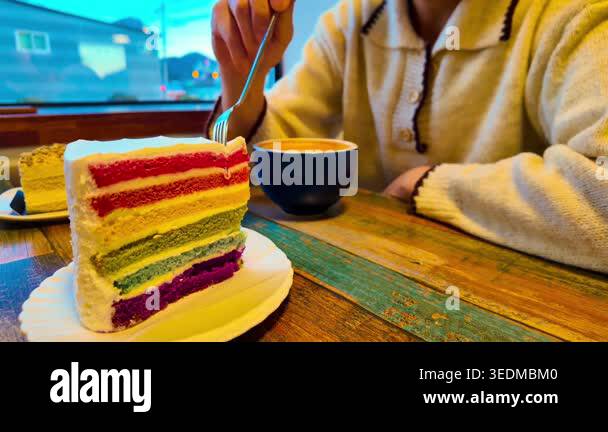Woman eats fresh baked homemade Rainbow cake with coffee. High quality ...