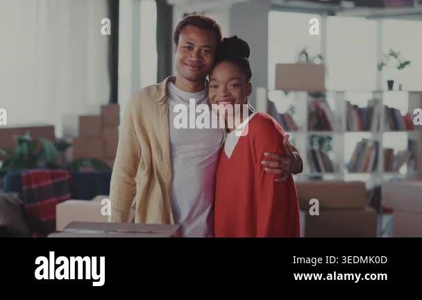 black couple smiling and embracing in new living space, cozy portrait ...