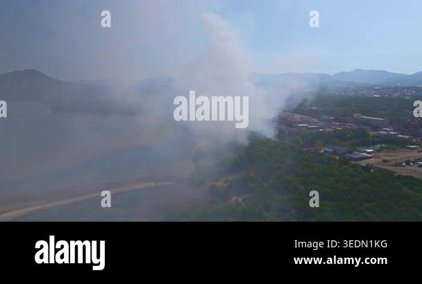 Aerial view of white smoke billowing from a burning landfill in Phuket ...