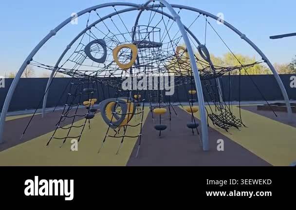Modern playground with slides, climbing structures, and bridges in a ...