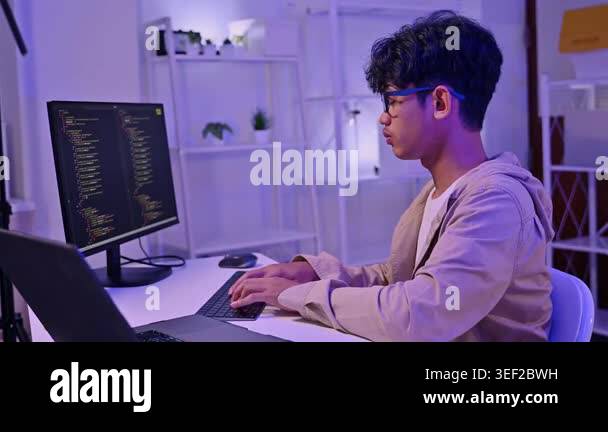 Young asian male software developer write code and program on desktop ...