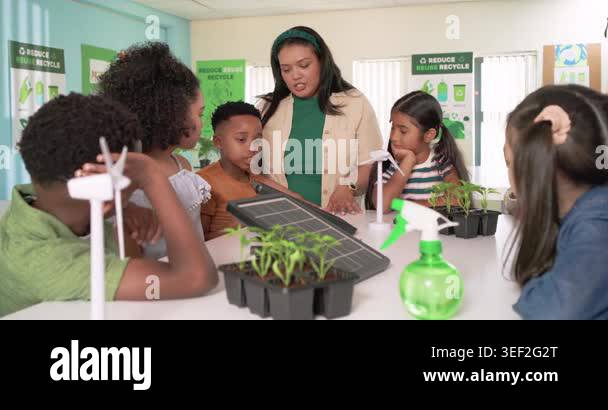 Teacher with students showing tilted solar panel at table, children ...