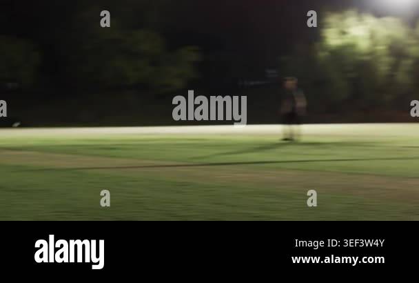 Indian male batsman under floodlights hitting shot, sprinting for two ...