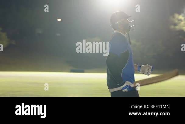 Bowler running in, batsman swinging bat clearing boundary, male ...