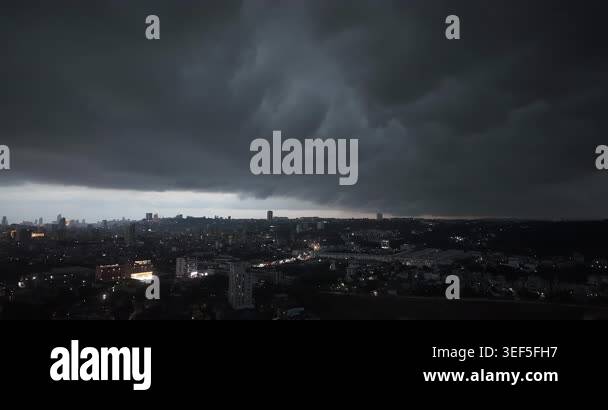 Wide angle night view of a massive shelf cloud advancing over a city ...