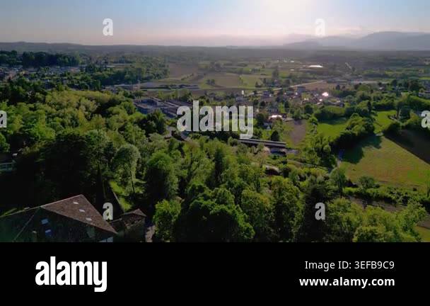 Aerial view of a lush green landscape with a small village under a ...