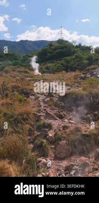 A solitary woman walks through a sunlit volcanic valley in El Salvador ...