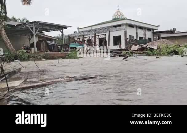 High-angle view of brown floodwater rushing through a construction site ...