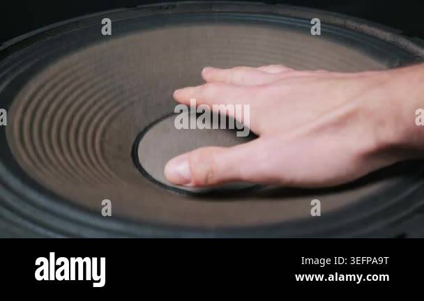 A close-up of a hand gently touching the large corrugated cone of a ...