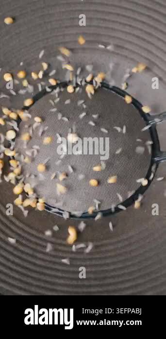 Rice and yellow lentils bounce chaotically on a vibrating audio speaker ...