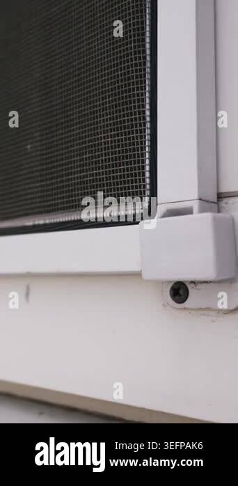 A detailed close-up shows a white plastic window frame with a durable ...