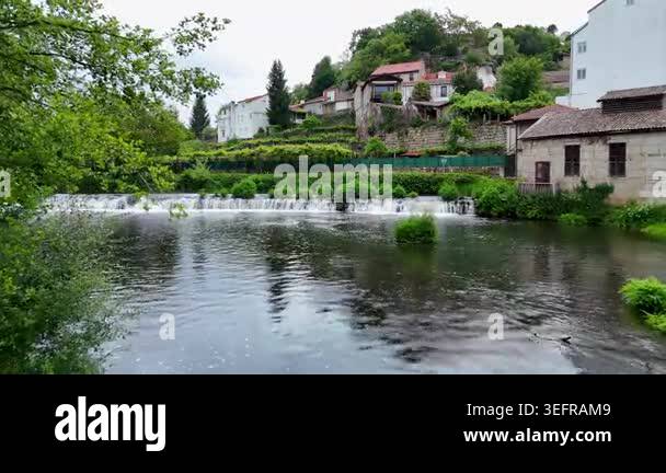 Picturesque view of the Arnoia River flowing through the town of ...