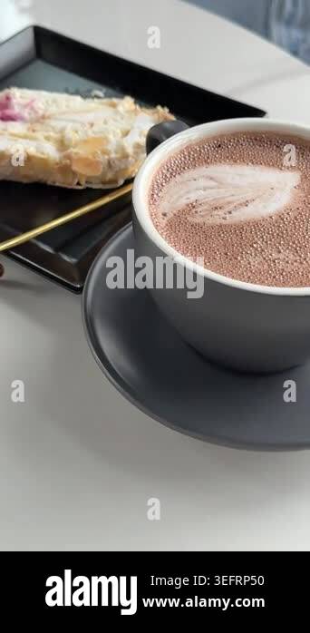 Close up of a cup of hot chocolate on a wooden tray at a terrace ...