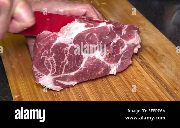 chef cut meat on cutting board with sharp knife for making healthy meal ...