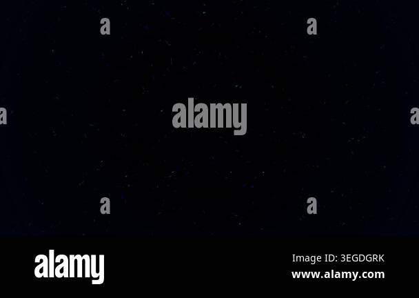 Abstract glowing particles and dust motes floating and falling on a ...