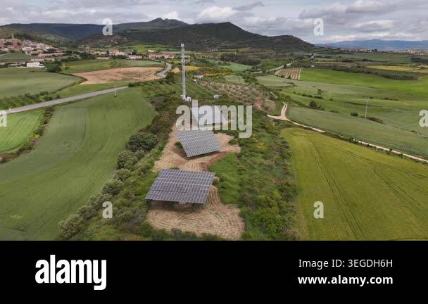 Aerial view of solar panels with tracking systems in a rural ...