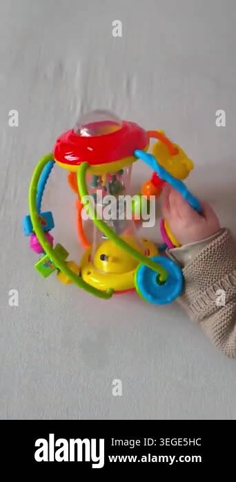 A small childs hand, clad in a warm knitted sweater, touches a ...
