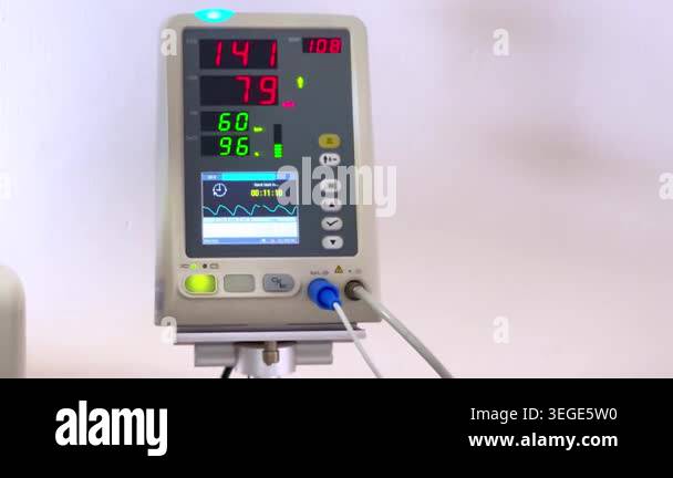 Close up patient vital signs monitor displaying heart rate, blood ...