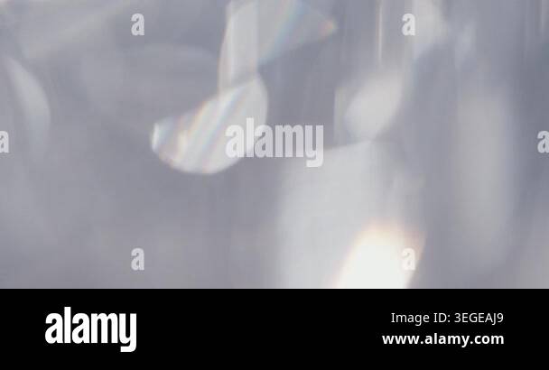 Abstract silver blurry background with moving lens flares and ...