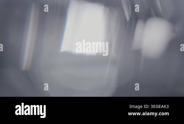 Abstract silver blurry background with moving lens flares and ...