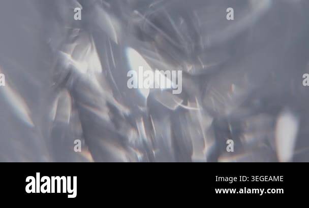 Abstract silver blurry background with moving lens flares and ...