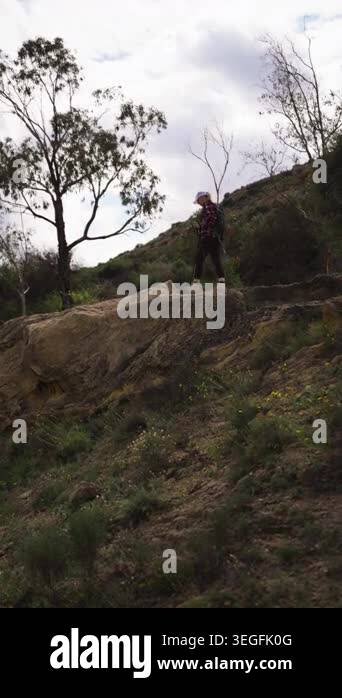 man climbing a rock with the mountain in background Stock Video Footage ...