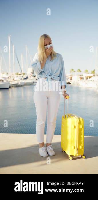 Young woman traveler wearing casual clothes, hold yellow suitcase while ...