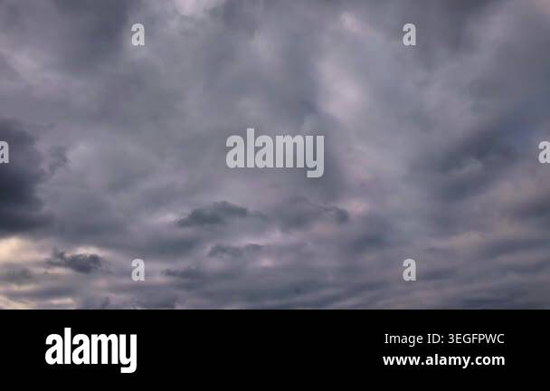 Ominous gray and purple overcast clouds fill the entire frame ...