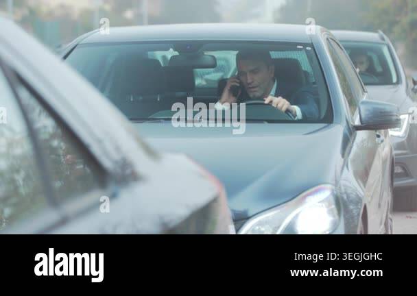 angry commuter arguing on phone in traffic, animated gestures and tense ...