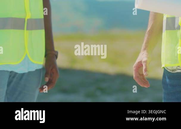 Contractor and architect handshake construction site, highvisibility ...