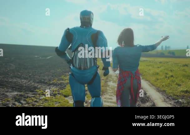 caucasian woman and robot strolling along muddy path, engineer ...