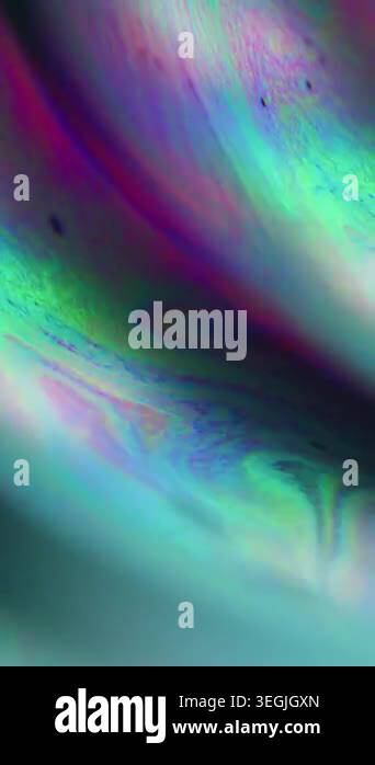 Vertical video. Defocused droplet oil. Color mix. Yellow pink blue ink ...