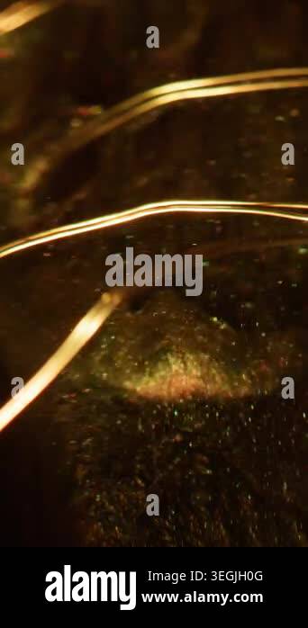 Vertical video. Fairy light. Glitter texture. Defocused yellow golden ...