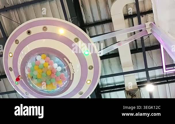Colorful Ball Drop Inside Futuristic Circular Machine at Modern ...