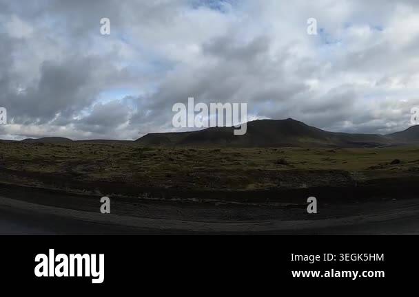 Fast-moving POV driving shot through Icelandic lava plains covered in ...