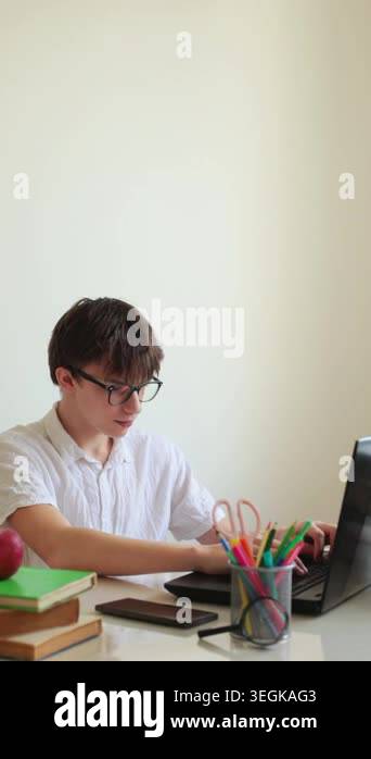 Teenager boy studying online at laptop, back to school concept, e ...