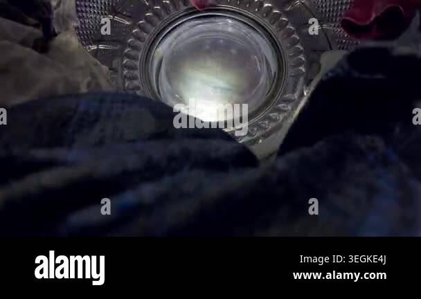 Machine Water Reflection Creative view from within a washing machine drum. Water splashes and ...