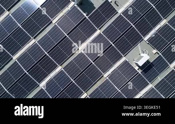 High-angle aerial drone shot of a large solar panel installation on a ...