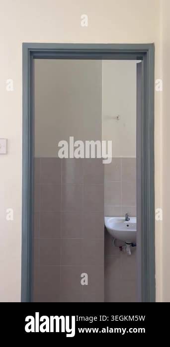 A faulty white led light tube flickers rapidly on a bathroom ceiling ...