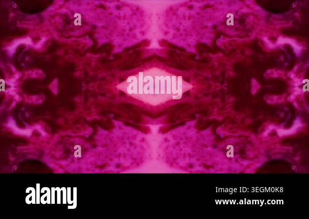 An abstract, symmetrical kaleidoscope pattern in shades of pink and red ...