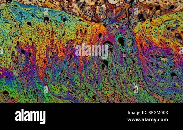 A high-definition stock video capturing swirling, colorful liquid ...