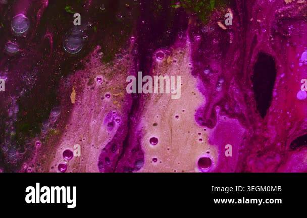 A dynamic stock video capturing flowing liquid with vibrant purple and ...
