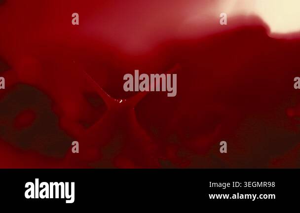 This shows the process of red liquid mixing with light and texture on a ...