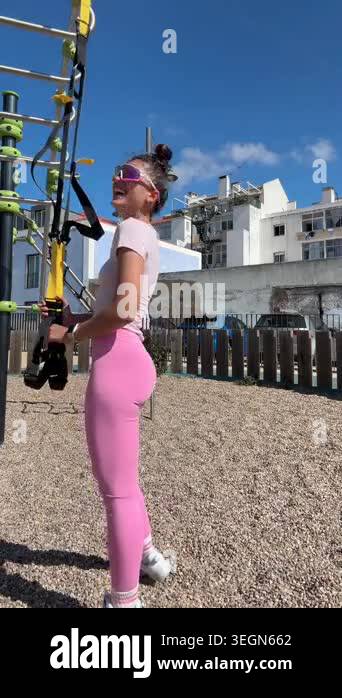 Pink workout outfit white woman dancing with suspension straps ...